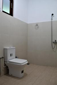 a bathroom with a toilet and a shower at Amado Homestay Ella in Ella