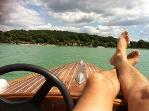 a person with their feet up on a boat on the water at Castrum Bucowe in Buckow