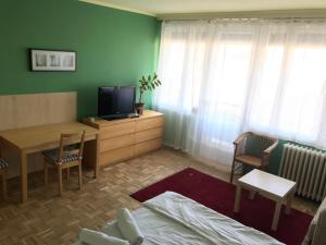 a living room with a television and a table and chairs at Budapest Flat Rent in Budapest