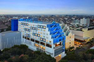 a building with blue stairs on the side of it at Novotel Suites Yogyakarta Malioboro in Yogyakarta