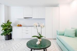 a living room with a couch and a table at Suite Plumbago in Sant'Agnello