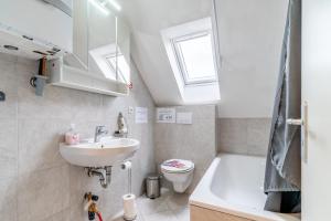 La salle de bains est pourvue d'un lavabo, de toilettes et d'une baignoire. dans l'établissement Private Apartment, à Hanovre