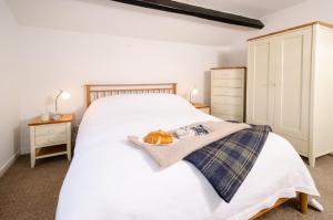 a bedroom with a large white bed and two night stands at High Barn, Ambleside in Ambleside