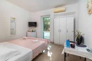 a bedroom with two beds and a sliding door at Rooms Feme in Trogir