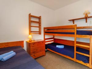 a bedroom with two bunk beds and a night stand at Holiday Home Villa Cassiopee by Interhome in Llança
