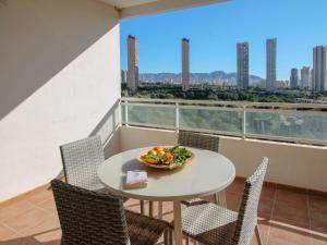 a table and chairs with a bowl of food on a balcony at Apartment Terramar-1 by Interhome in Benidorm