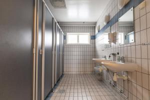 a bathroom with two sinks and a window at Vansbro Camping in Vansbro