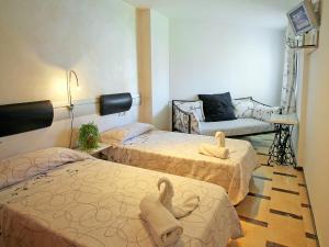 a room with two beds with towels on them at Apartment Sol Y Mar by Interhome in Altea