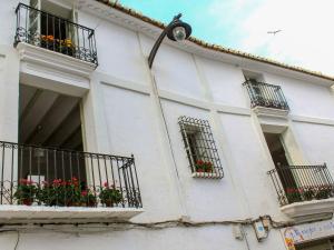 a white building with windows and balconies with flowers at Apartment Albir by Interhome in Altea