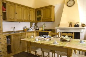 a kitchen with wooden cabinets and a wooden table at Montanari Agrivillage in Narni