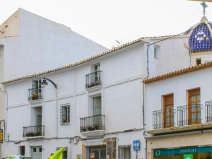 a white building with balconies on a street at Apartment Luna by Interhome in Altea