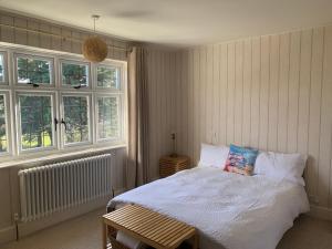 a bedroom with a bed and two windows at Picaroons Bed and Breakfast in Sheringham