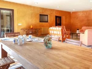 a living room with a wooden table and chairs at Holiday Home La Tilia by Interhome in Calonge