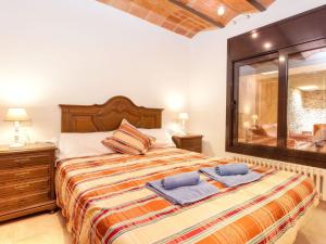 a bedroom with a large bed with towels on it at Holiday Home La Tilia by Interhome in Calonge