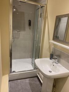 a bathroom with a shower and a sink at Royal Oak Hotel in Leicester