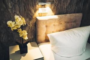 a bed with a pillow and flowers on a table at S-HOF in Sonnenbühl +32 photos