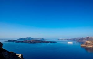 a large body of water with a boat in it at Suites of the Gods Cave Spa Hotel in Megalokhori