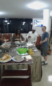 a group of people standing in a kitchen preparing food at Zagwe Hotel in Lalībela
