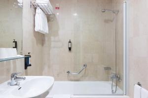 
a bathroom with a sink, toilet and shower stall at Hotel Meira in Vila Praia de Âncora
