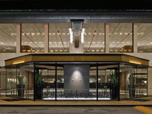 a store front of a building with potted plants at Hotel Nikko Narita in Narita