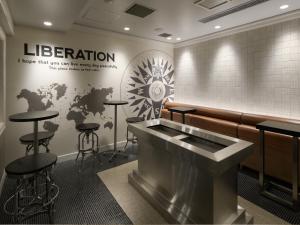 a bar with stools and a sign that reads liberation at Hotel Nikko Narita in Narita