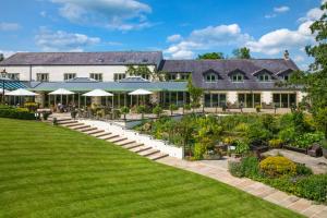 an exterior view of a building with a garden at Gibbon Bridge Hotel in Clitheroe