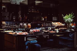 a bar with a lot of food and drinks at Monsieur Cadet Hotel & Spa in Paris