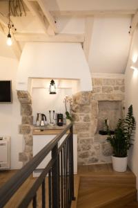 a staircase in a loft with a stone wall at Villa Four Winds IV in Dubrovnik