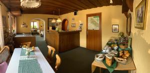 a dining room with a table and a kitchen at Pension Erna in Zwiesel