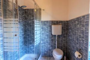 a bathroom with a shower and a toilet and a tub at Ap. Artù - Lago di Garda in Tremosine Sul Garda