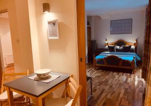 um quarto com uma cama e uma mesa com uma tigela em The Cowgatehead Residence em Edimburgo