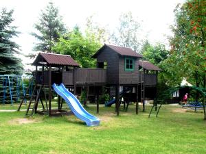 a playground with a slide and a play house at Ośrodek Szeligi in Ełk