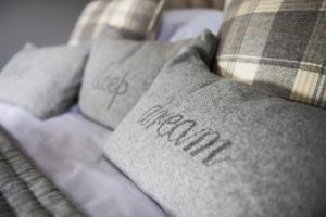 a close up of pillows on a bed at Duke of Portland Boathouse on the shore of Lake Ullswater ideal for a romantic break in Pooley Bridge