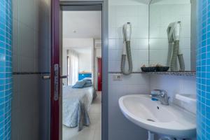 a bathroom with a sink and a mirror at Hotel Morotti in Misano Adriatico +68 photos