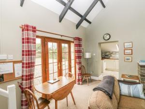 a living room with a couch and a table at Foxglove Cottage in Haverfordwest