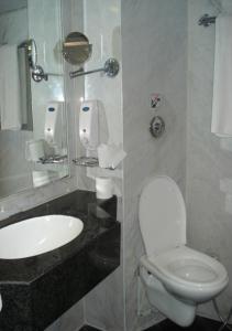 a bathroom with a white toilet and a sink at Nile Carnival Cruise 4nt Lxr Thursday 3nt Asw Monday in Luxor