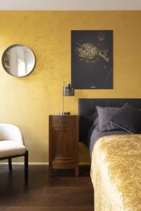a bedroom with a bed and a mirror and a chair at Ca D Oro Cannareggio in Venice