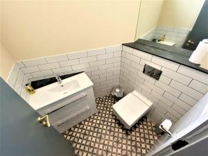 a bathroom with a sink and a toilet at The Leeming at Claremont Apartments in Leeds +16 photos