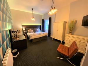 a hotel room with a bed and a chair at The Leeming at Claremont Apartments in Leeds