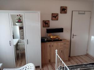 a living room with a dog statue on top of a dresser at B&B Im Bitzi in Zuzwil