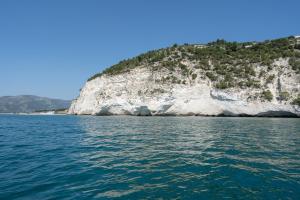 a view of a white cliff from the water at La Locanda Del Carrubo in Mattinata