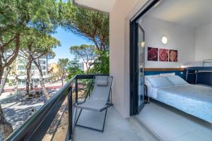 a bedroom with a bed and a balcony at Hotel Morotti in Misano Adriatico