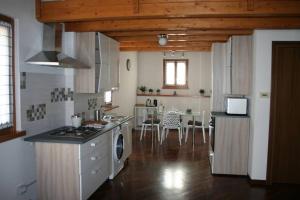 a kitchen with a stove top oven next to a table at Country Corner Lago Maggiore in Divignano