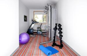 a room with a gym with a treadmill and a mirror at GINGER Noida City Center in Noida