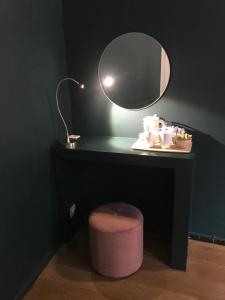 a bathroom with a lamp and a mirror at Hotel Goezeput in Bruges