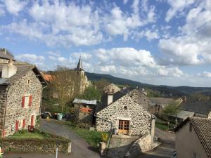 an old village with a church in the background at Auberge de la Tour in Freycenet-la-Tour