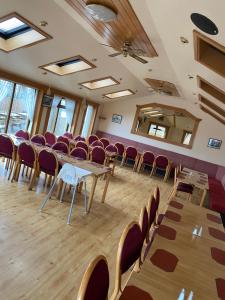 a conference room with tables and chairs in it at Bessemer Hotel in Merthyr Tydfil