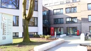 a building with two red phone booths in front of it at Europa-Haus-Bocholt - Bett & Bike in Bocholt