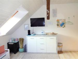 a living room with a tv on the wall at Gästezimmer in Bad Urach in Bad Urach