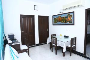 a dining room with a table and chairs in a room at joerose villa in Noida